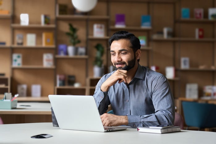 Man sitting in front of a laptop