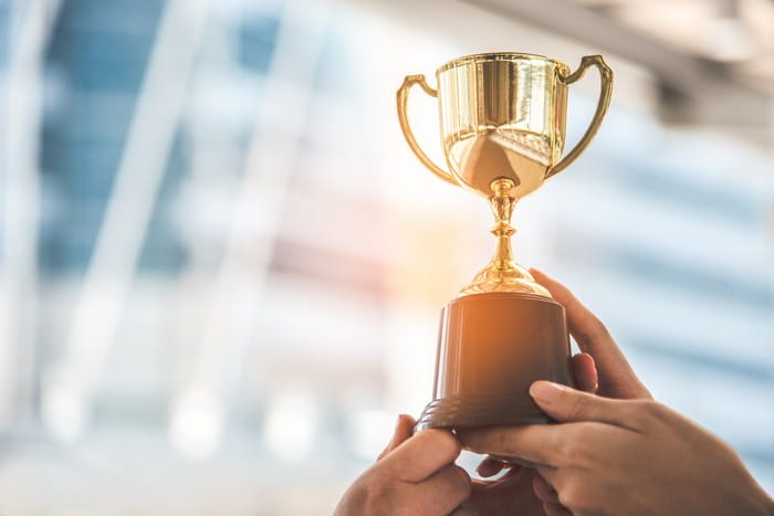 Image of golden trophy being held up