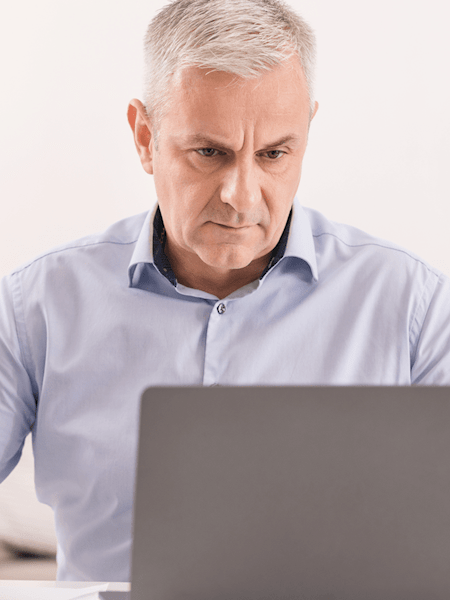 Middle aged man working on laptop