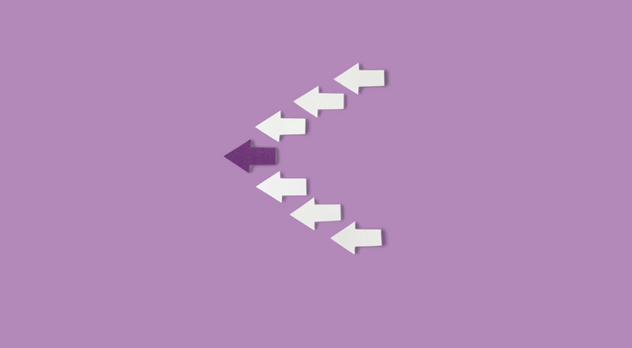 Paper arrows on a purple background