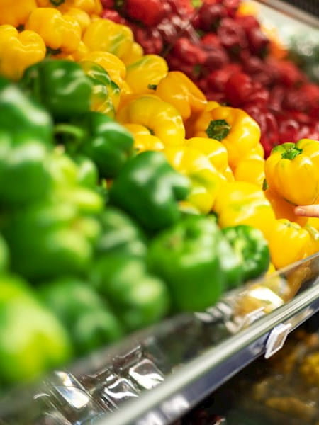 Green yellow and red peppers at supermarket