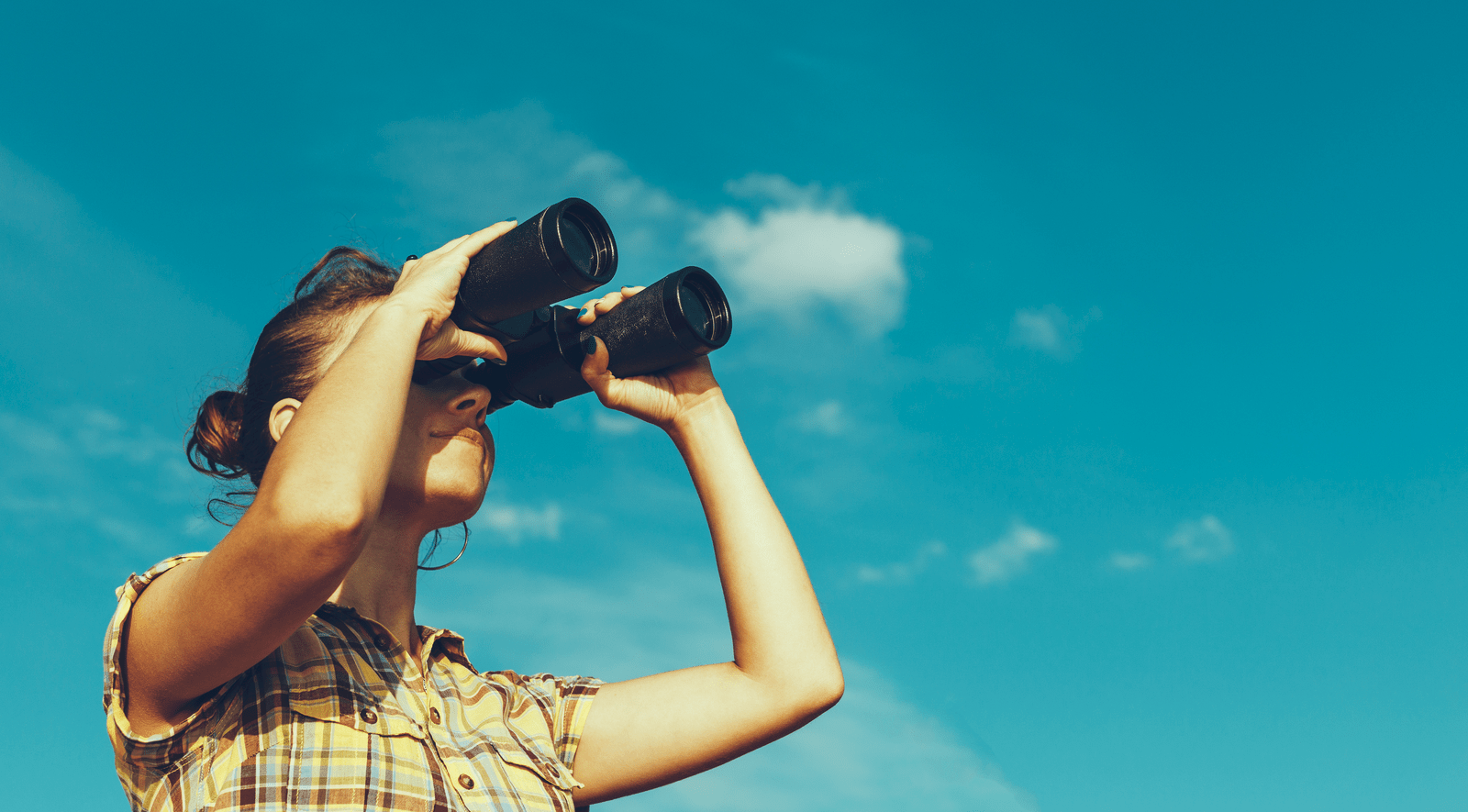 Woman looking with binoculars