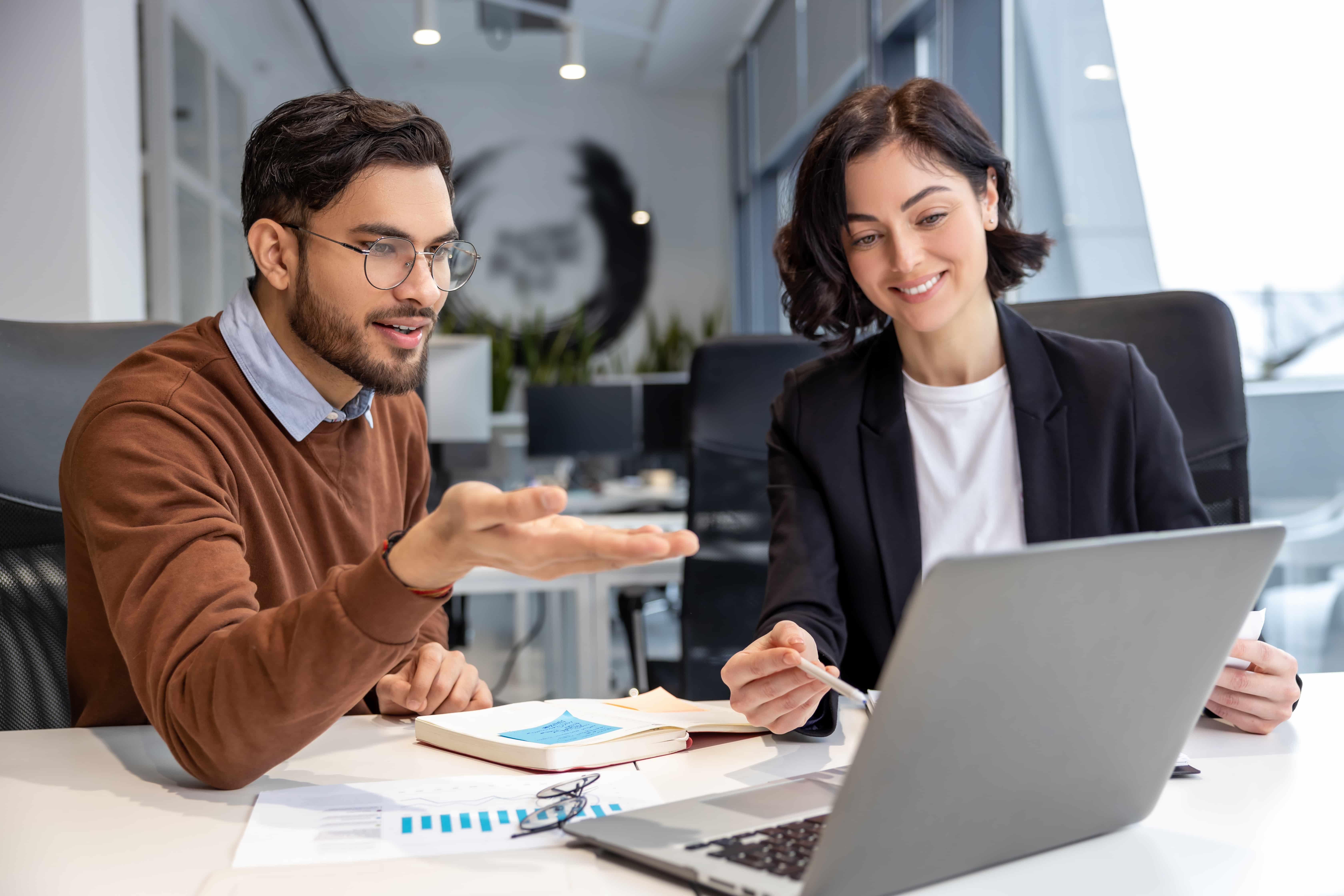Two people looking at a laptop