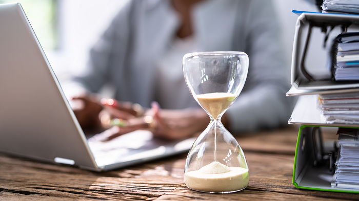 Sand timer with person working at a desk