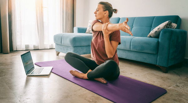 Woman doing yoga class online