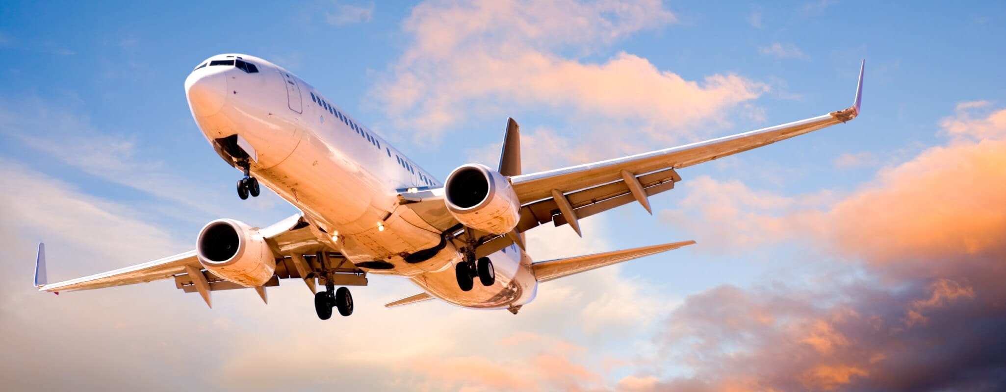 Aeroplane flying at sunset
