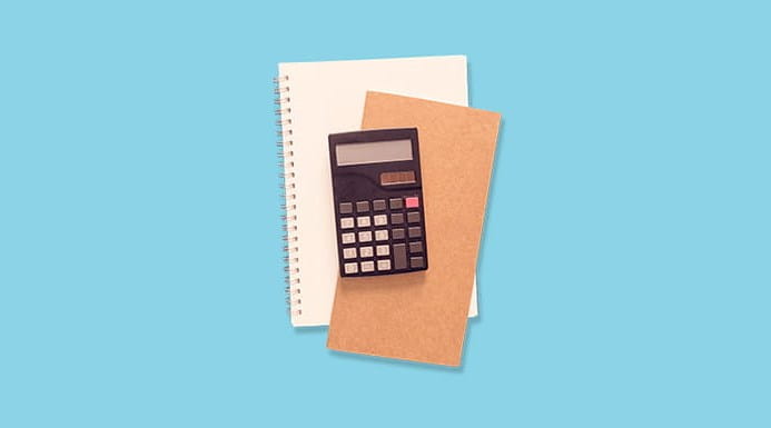 A calculator, notebook and envelope
