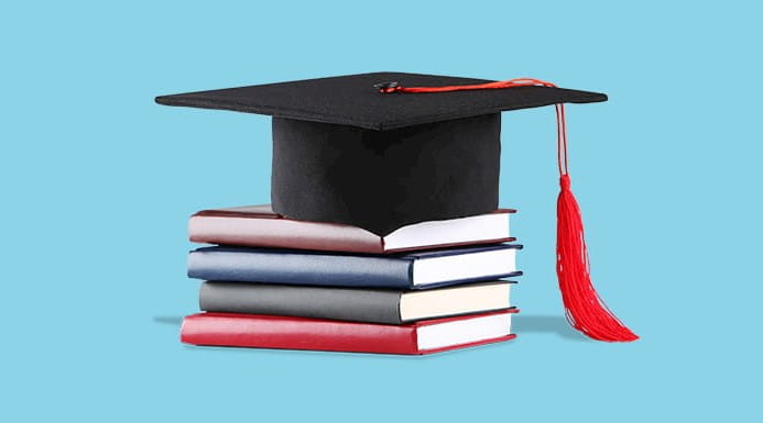 A mortarboard on top of a pile of books