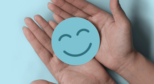 Hands holding a smiley face