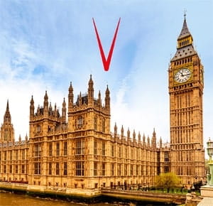 The Palace of Westminster in London, featuring its iconic Gothic architecture and the Elizabeth Tower (commonly known as Big Ben) with a clock face visible. The building is set against a bright blue sky with scattered clouds.