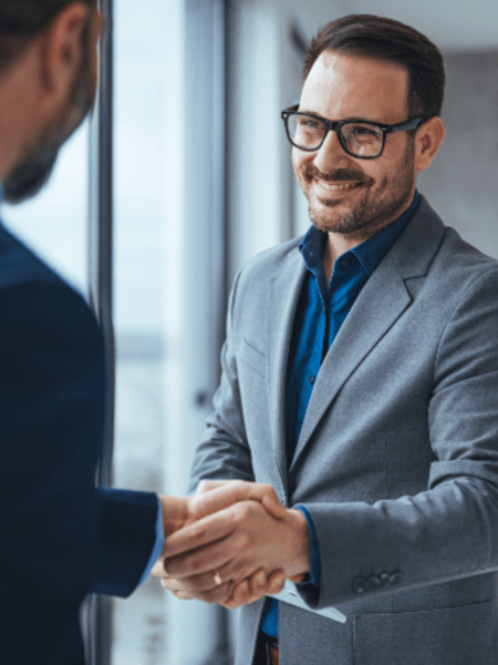 Man in glasses smiling at camera
