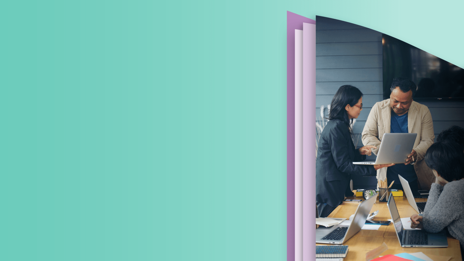 Three people working on their laptops at the desk 