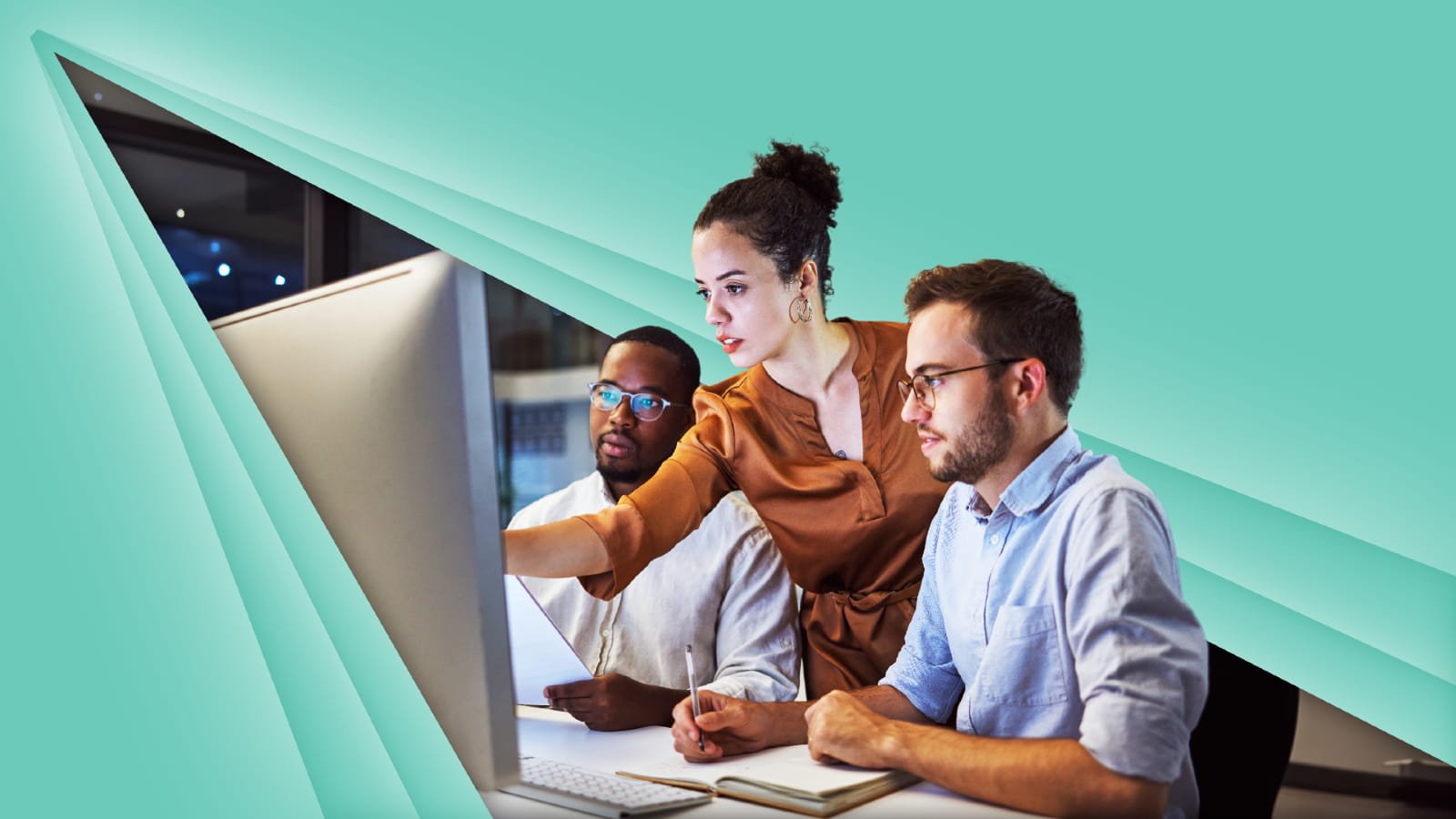 3 people working on a computer against a teal background