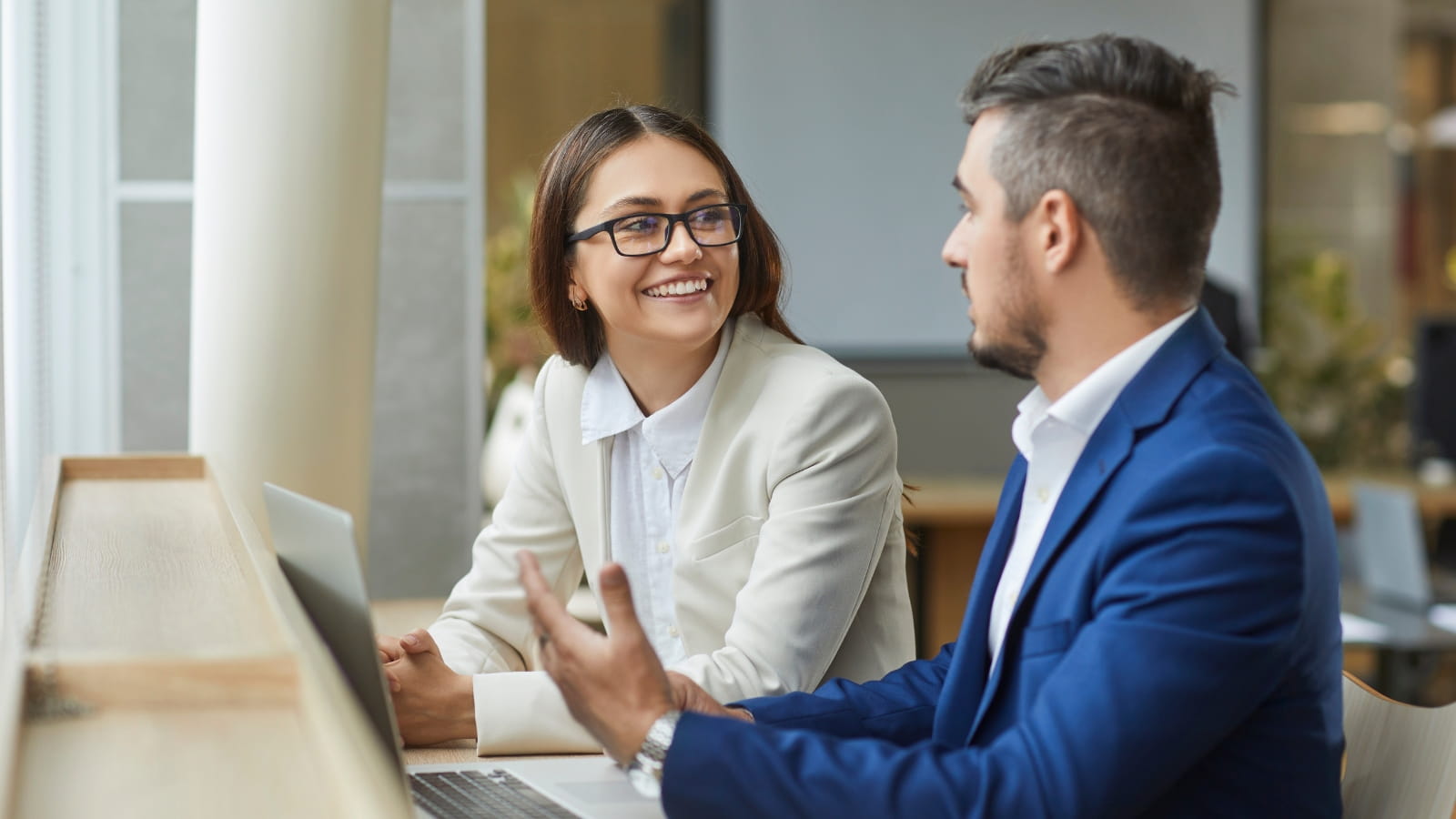 Two colleagues having a meeting discussing a topic together.