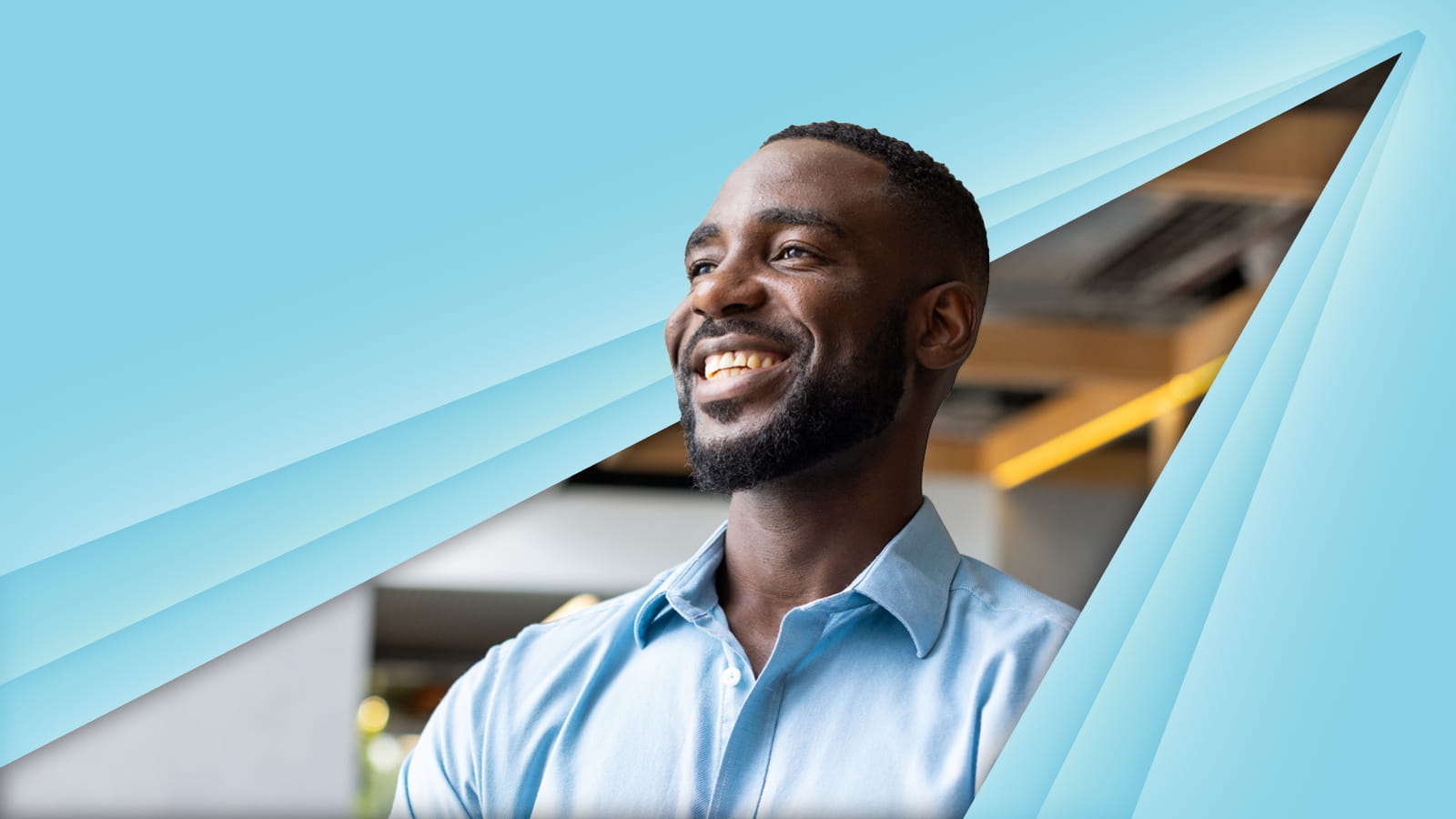 A man posed an smiling with a blue background
