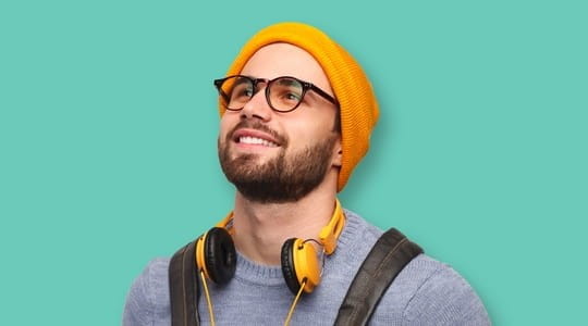 Young man wearing yellow hat and headphones