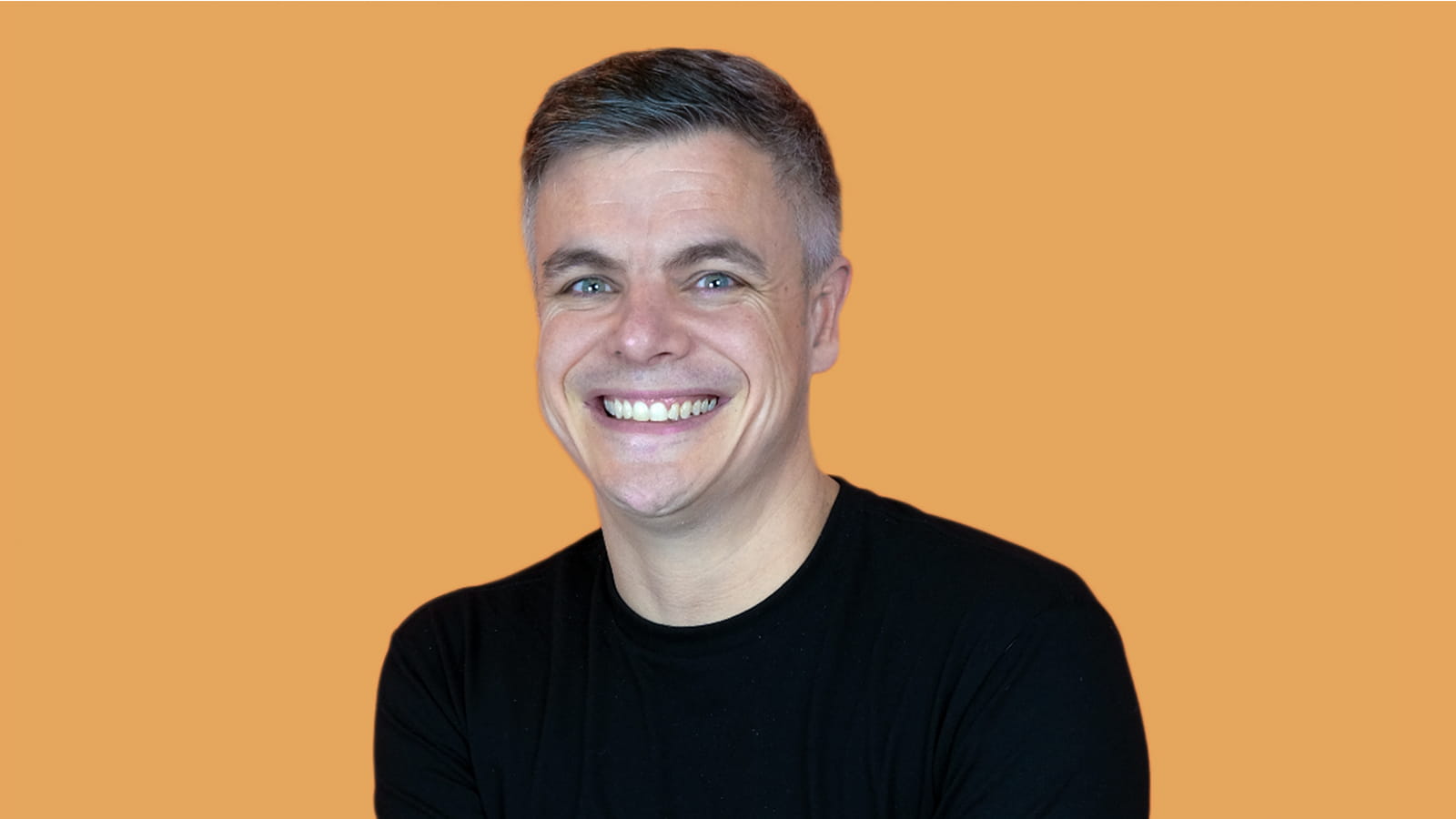 photo of Carle Moore on an orange background