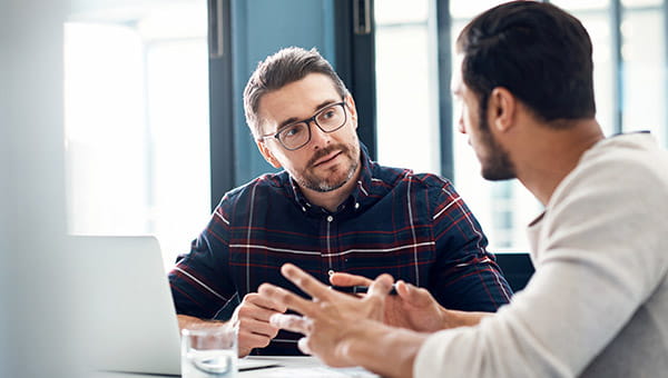 Two men having a discussion at work