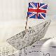 origami boat made out of newspaper with a Great Britain Union Jack flag stuck in it