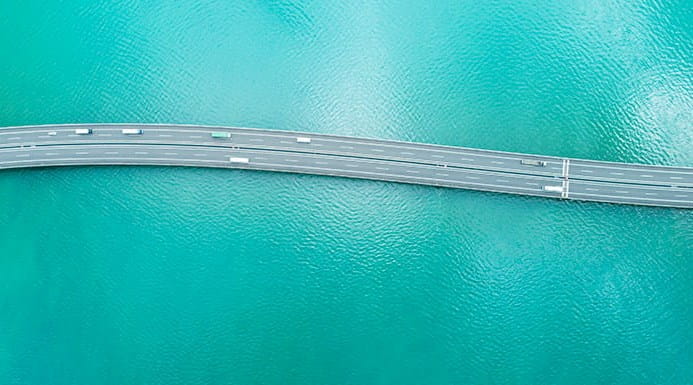 A road stretching over turquoise water