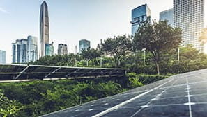 Solar panels with a cityscape in the background