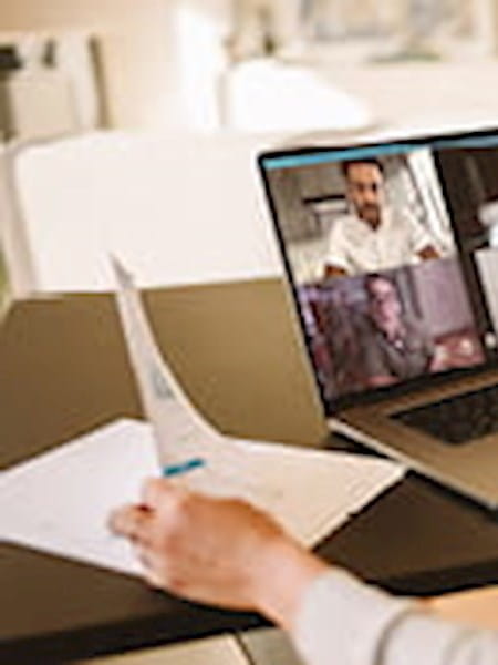 A virtual meeting taking place on a laptop