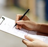 Person going through a checklist with a pen