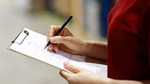 Woman holding a checklist