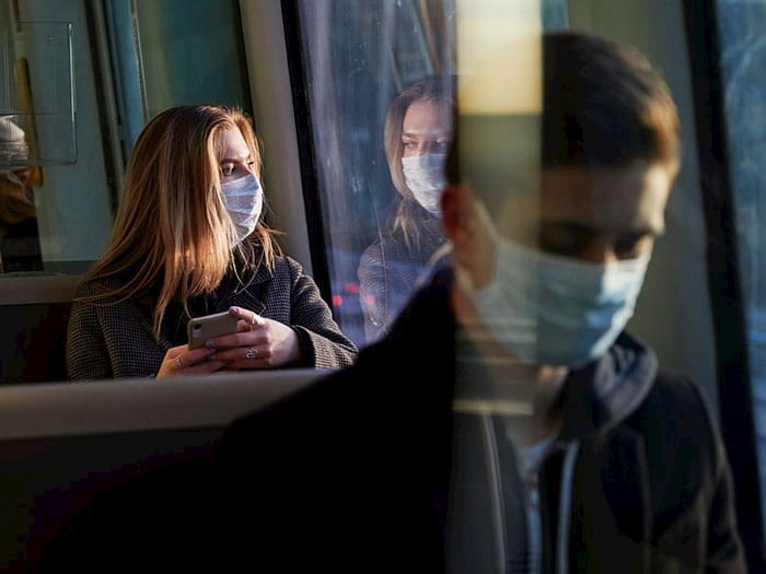 Coach passengers wearing facemasks