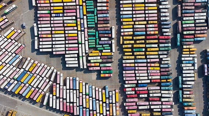 Aerial view of a sea of parked multicoloured coaches