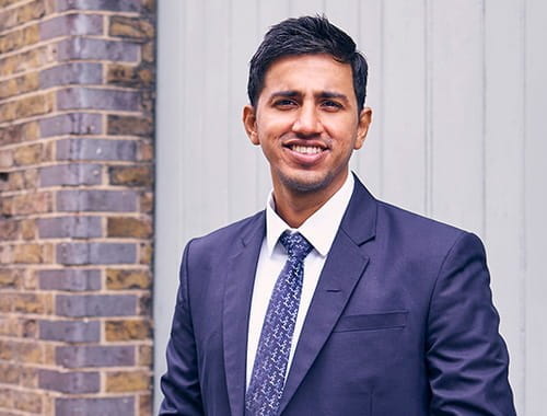 Kamidu Ravindra, accountancy insurance specialist, EY, young Sri Lankan man in a navy suit, London