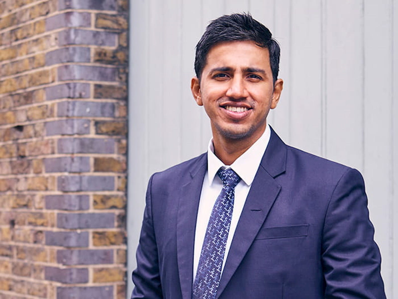 Kamidu Ravindra, accountancy insurance specialist, EY, young Sri Lankan man in a navy suit, London