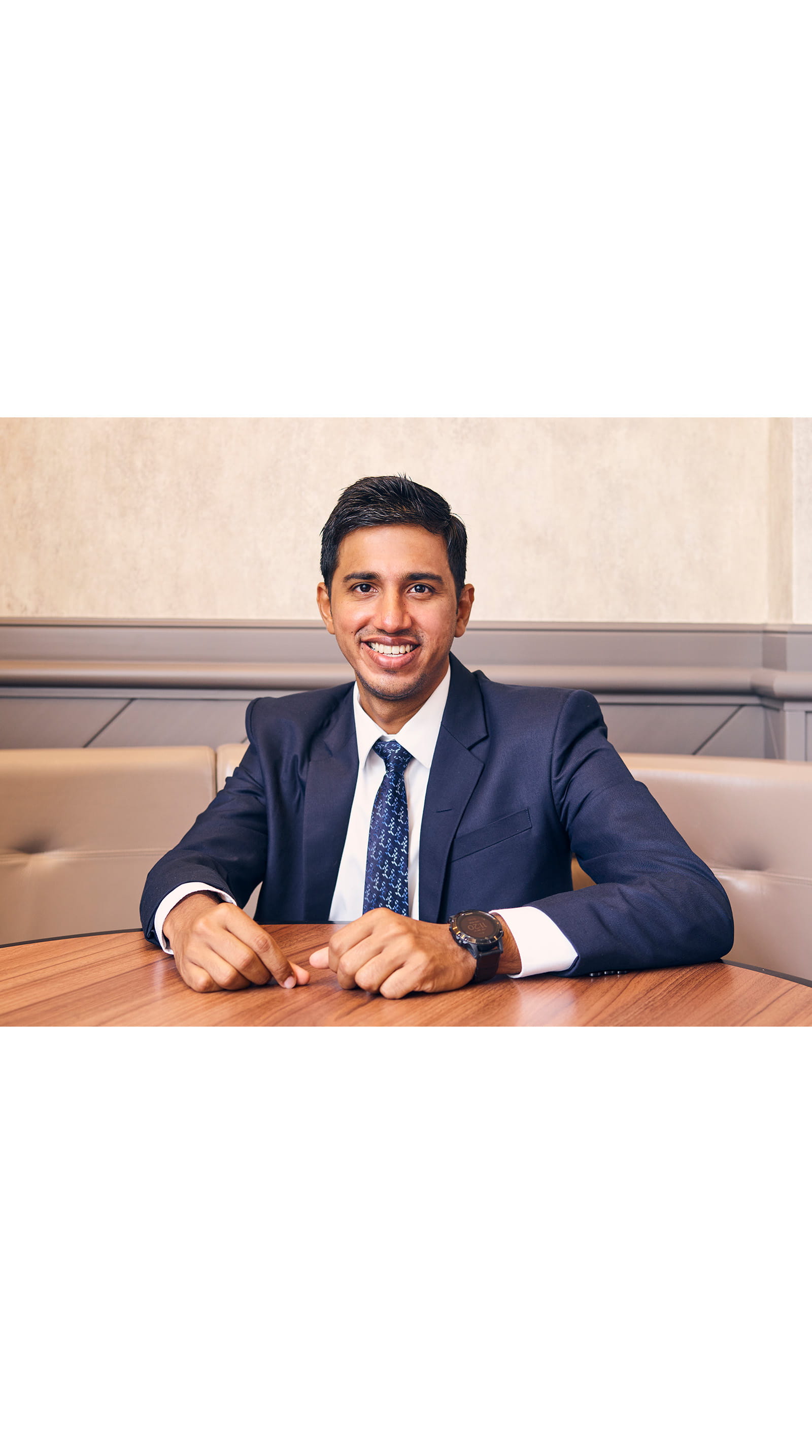 Kamidu Ravindra, accountancy insurance specialist, EY, young Sri Lankan man in a navy suit, London