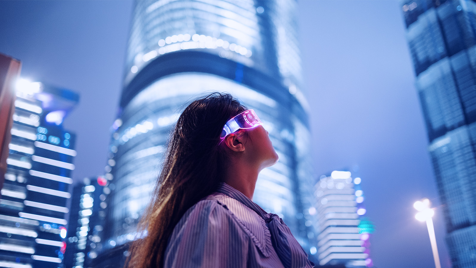 Young businesswoman standing against contemporary financial skyscrapers in the downtown financial district