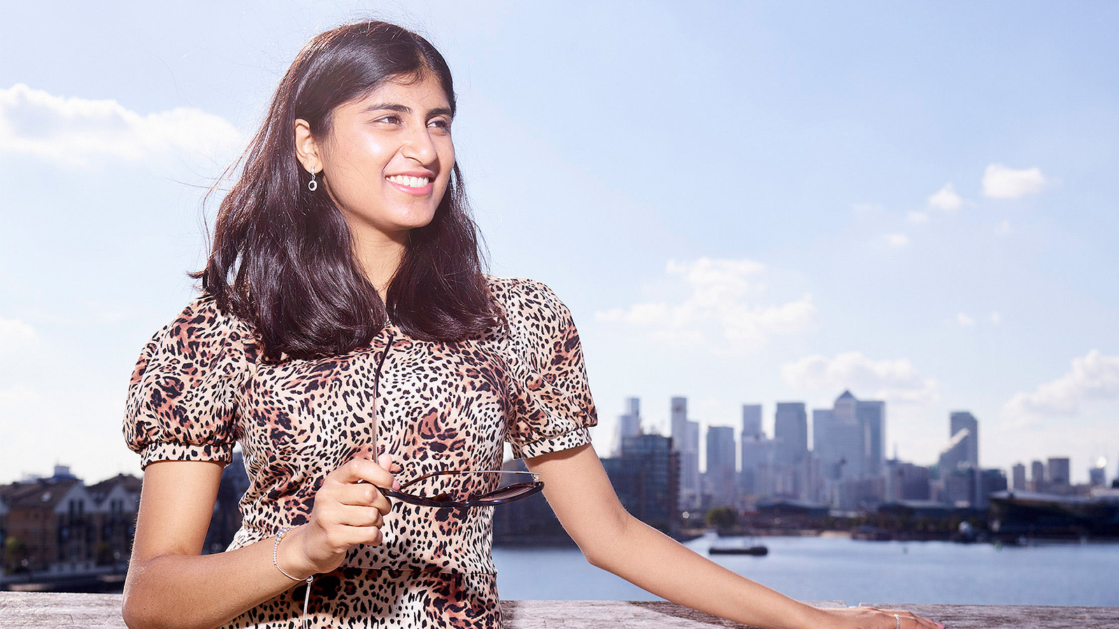 Audit trainee and ACA student Ashwini Poopalasingham standing in front of the Thames river, London city, UK