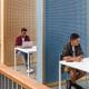 row of students in study area exams cubicles