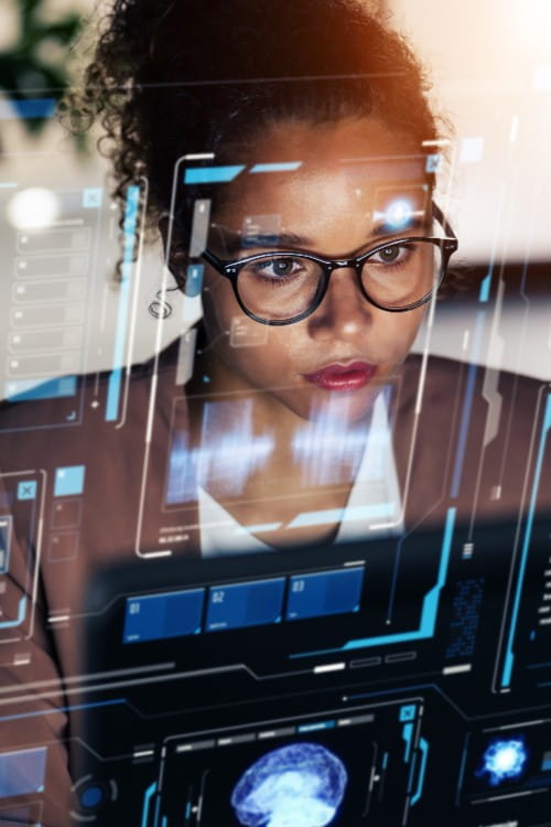 Black woman looking at data on a glass screen