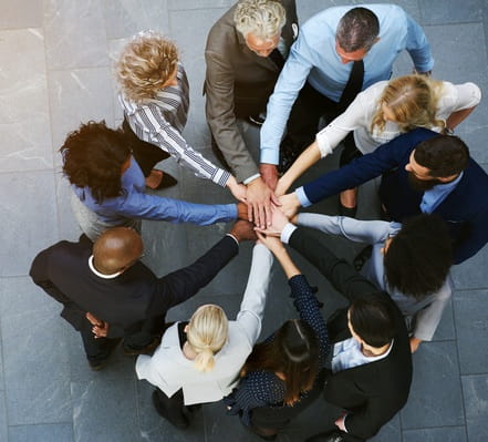 Circle of people joining hands in the middle