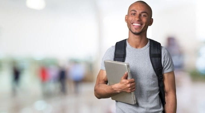 Young person holding laptop