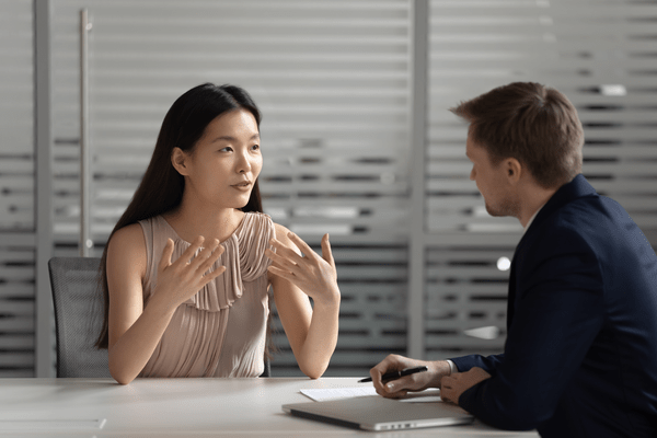 asian woman talking to colleague