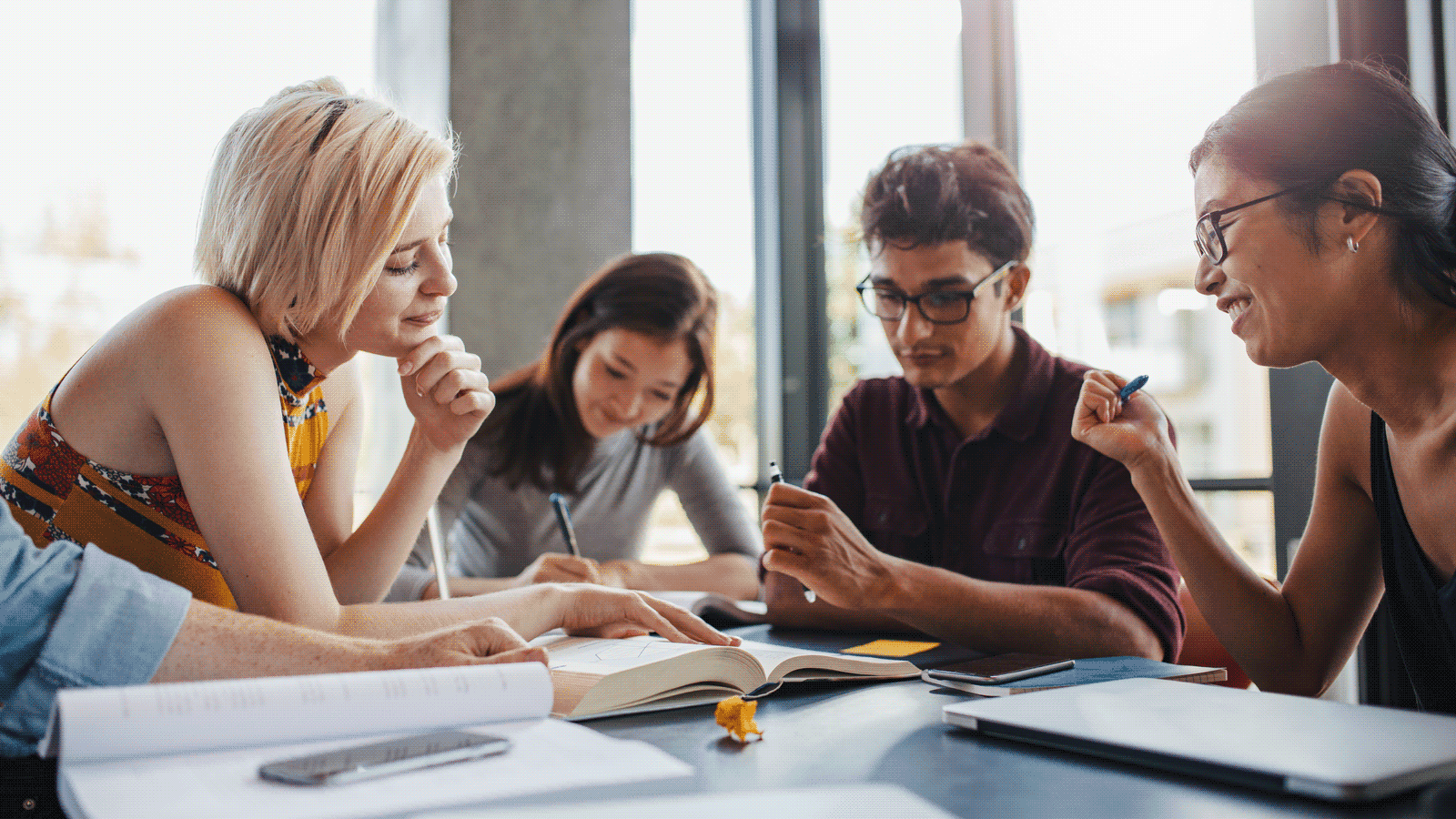 diverse young people working at a table