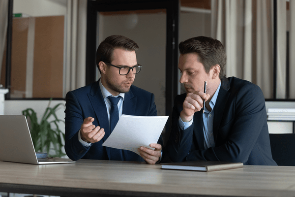 two professional men discussing work