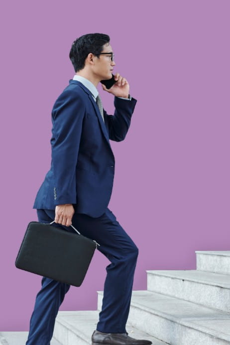 Image of man walking up stairs with briefcase and phone