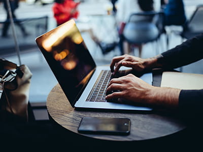 A pair of hands at a laptop