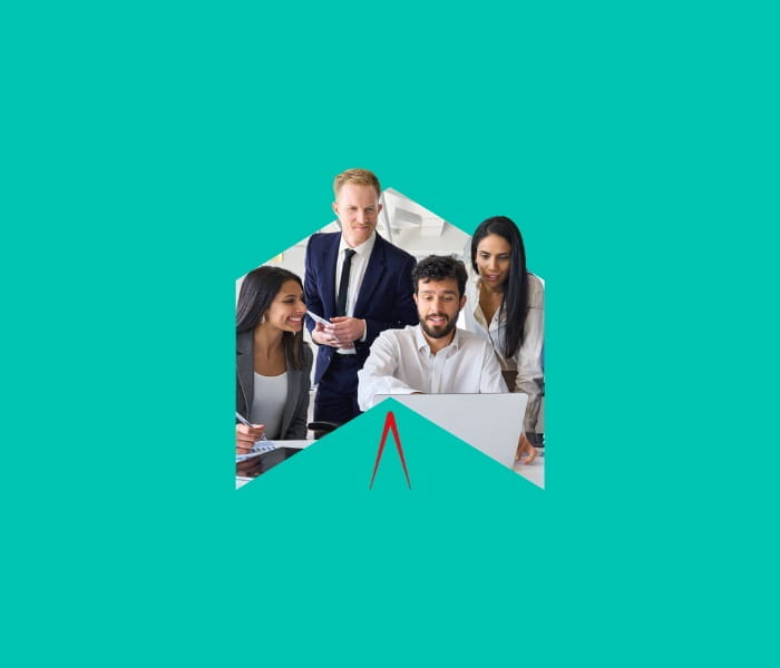 A group of smartly-dressed people viewing a laptops screen