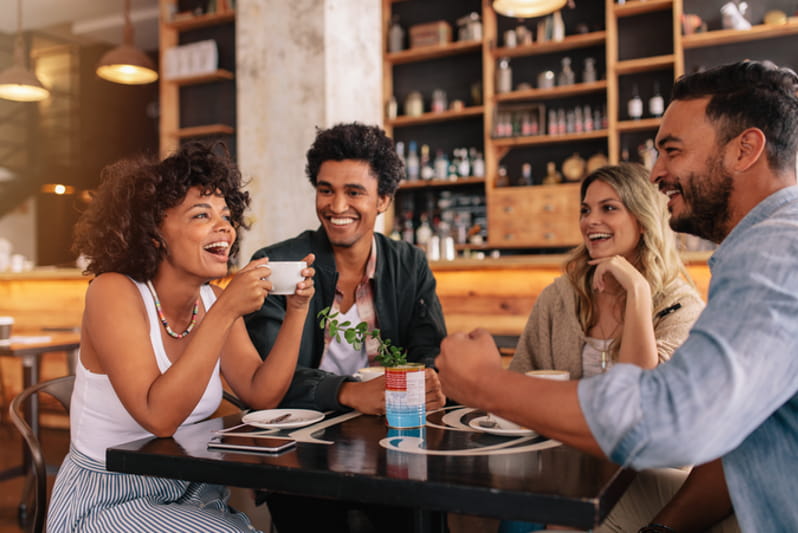 Diverse black and white young business people laughing and smiling together.