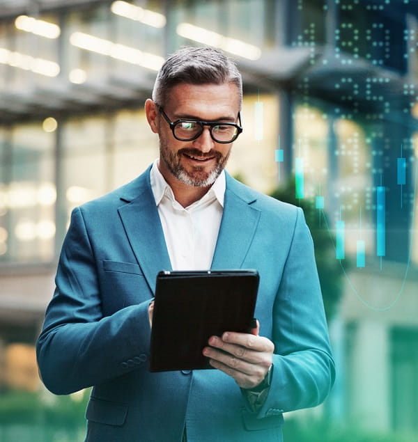 Man on tablet in front of office building