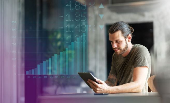 Man on tablet with graph background