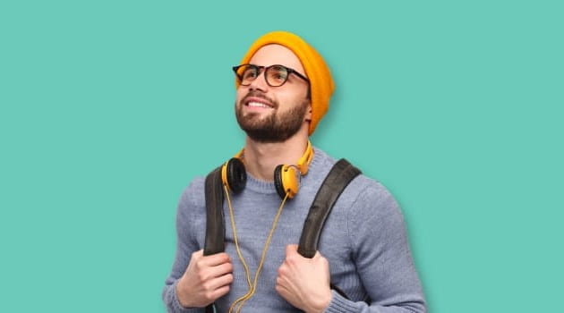 Young man wearing yellow beanie and headphones