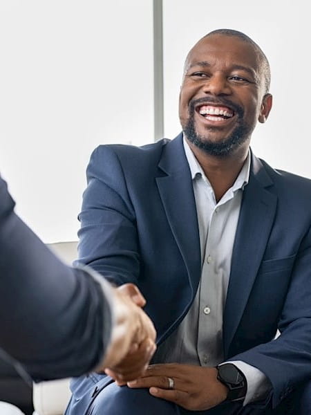Black man in a suit shaking hands